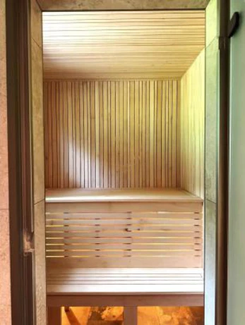 Wooden sauna interior with bench and slatted walls