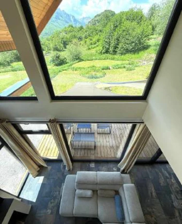 Modern living room with large windows and mountain view